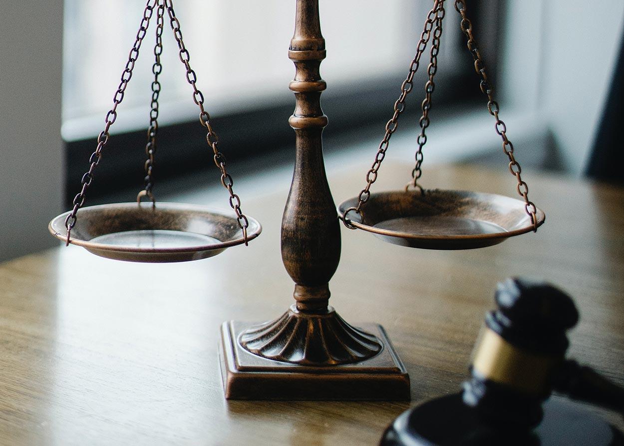 scales of justice next to wooden gavel